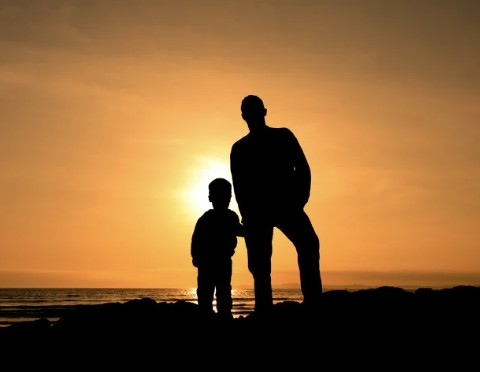 father and child on shore