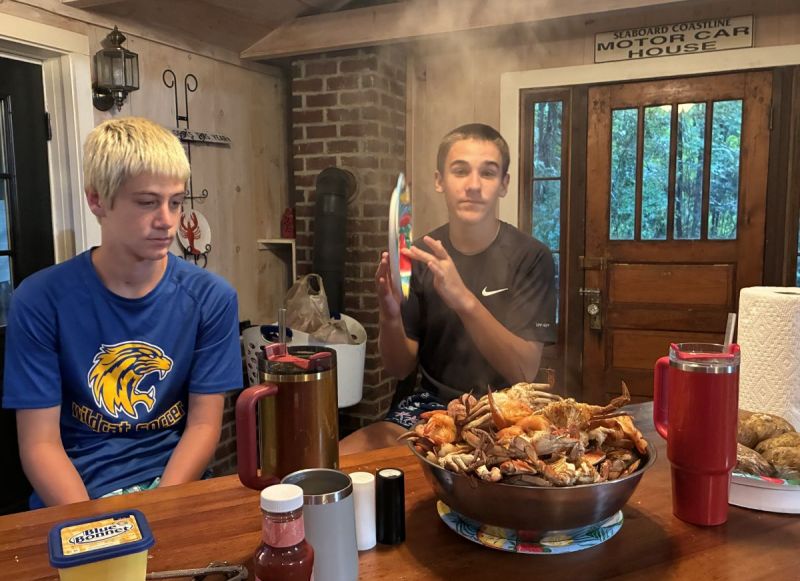 Kyler and friend (John) about to eat their bountiful catch of blue crabs